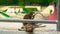 Concept of contrasting nature and city.Slowmotion shot of wild monkeys sitting at the background of a skate park