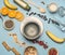 Concept of cooking healthy breakfast, berries, bananas, oranges, cereals, and milk, a vintage bowl on a blue background flat lay