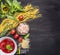 Concept cooking pasta with shrimp, tomato paste, cheese and herbs on wooden rustic background top view border ,place text