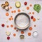 Concept cooking vegetable soup with carrots and spinach, vintage pan around which laid out ingredients and seasonings place fo