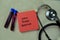 Concept of Cord Blood Banking write on sticky notes with stethoscope isolated on Wooden Table