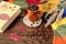 The concept of cozy autumn days: a cup with coffee beans among knitted objects, books and scattered autumn leaves, side view