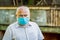 Concept danger of coronavirus for the elderly. Portrait old man in a surgical bandage, coronavirus, medical mask. Old