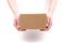 Concept of delivery, package, storage, transfer of the package. Women`s hands hold a cardboard box on a white background