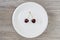 Concept of dieting and healthy eating. Red juicy cherries on white round plate. Wooden background, top view starving starvation we
