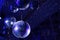 The concept of disco. Light and music disco ball on a blue background. A rotating disco ball in a nightclub with