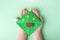 Concept of DIY and kid`s creativity, origami. Child`s hand holding bookmark as christmas tree. Children`s New year craft