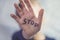 Concept of domestic violence and child abusement. A little girl shows her hand with the word STOP written on it. Children violence