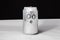 Concept of dumbfounded man. confused emoticon on aluminium 0.25l can, Emoji with surprised face. On black background