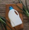 The concept of eco-friendly natural detergents. A plastic white bottle of detergent on bath linen with an aloe vera medicinal