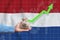 The concept of economic growth in Netherlands. Hand holds a bag with money and an upward arrow