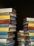 Concept Of Education And Knowledge. Tower Building Of Old Colorful Books On Black Background