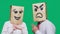 The concept of emotions and gestures. Two people in paper bags with a smile. Aggressive smiley swears. The second looks