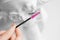Concept Eyelash extension procedure, master comb brush fake lashes on woman