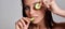 Concept Face care at home. Portrait of young beautiful woman with cucumber on her face