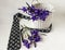 The concept of father`s Day celebration - a man`s tie with a bouquet of irises in a basket on a white background