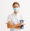 Concept of fighting and prevention coronavirus infection covid 19. woman doctor in protective medical  mask  with arms crossed