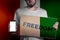 Concept of freedoms and human rights. A man with a cardboard and a phone in his hand. The Flag of Ireland. Mock up