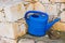 Concept of gardening. Blue watering can outdoor