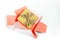 The concept of gift unwrapped from paper of living coral color on white background. Present for birthday, Valentine`s Day, holiday