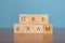 Concept of GRE Exam in wooden block letters on table