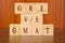 Concept of GRE vs GMAT Exam differences in wooden block letters on table