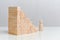 Concept of growth of requirements for an employee. Wooden blocks on a white background background