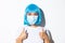 Concept of halloween celebration and coronavirus. Image of supportive smiling asian girl in blue wig and medical mask