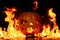 The concept of Halloween. The evil terrible pumpkin is burning i
