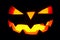 The concept of Halloween. The ghastly, ghastly pumpkin glows wit
