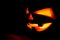 The concept of Halloween. The ghastly, ghastly pumpkin glows wit