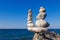 Concept of harmony and balance. Rock Zen on the background of summer sea.