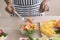 The concept of a healthy diet and lifestyle. Man is preparing a salad of various vegetables in the kitchen