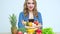 Concept of healthy eating, woman in the kitchen with a variety of vegetables and fruits