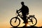 Concept of healthy lifestyle. Silhouette of cyclists at sunset