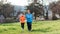 The concept of a healthy lifestyle and sports. Elderly and young women in sports clothes, running in the park