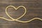 Concept of heart of the jute ropes, love, frame for greeting card on brown wooden background
