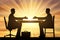 Concept hiring process. Silhouette of two men sitting at a table and stretching out their hands for a handshake