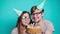 Concept of holiday and birthday. Young cheerful funny couple having fun with birthday cake