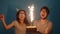 Concept of holiday and birthday. Young cheerful funny couple having fun with birthday cake