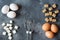 Concept of home cooking, eggs and sugar with a whisk on a dark table Selective focus
