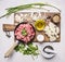 Concept of home cooking minced meat with vegetables, spices and herbs on wooden rustic background top view close up