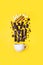 Concept hot chocolate recipe: chocolate pieces, spices and marshmallows on yellow background