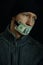 Concept image of corruption and bribery. Silent for money. Portrait of man with his mouth shut with one dollar banknote