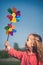 Concept image of happy child playing with windmill in Holland.