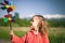 Concept image of happy child playing with windmill in Holland.