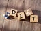 concept image a pills and wooden block word - DIET on wooden background with selective focus.