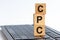 Concept image a wooden block and word CPC on white background. The cubes are located on the keyboard. Selective focus.