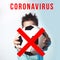 Concept on the issue of cancellation of football matches and competitions due to coronavirus. The guy holds the ball, crossed out