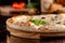 The concept of Italian cuisine. Thin cheese pizza with mushrooms, with large sides of Semola flour